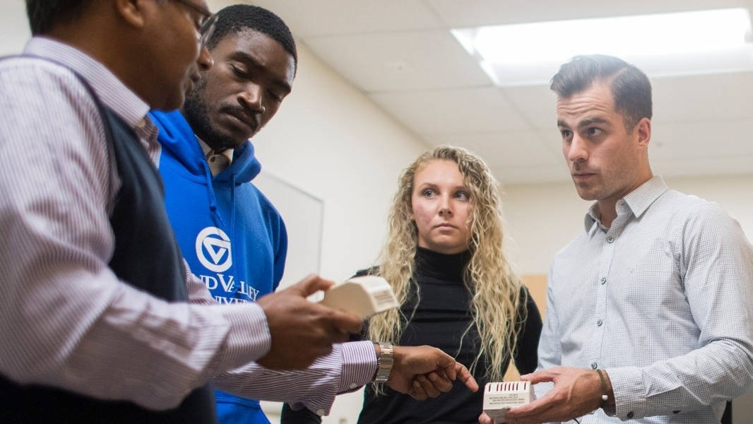 Students and faculty discuss in a classroom
